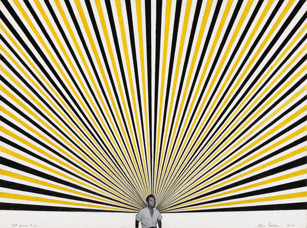 man smoking cigarette stands in front of a painting of rays of yellow and blue rays fanning out above him